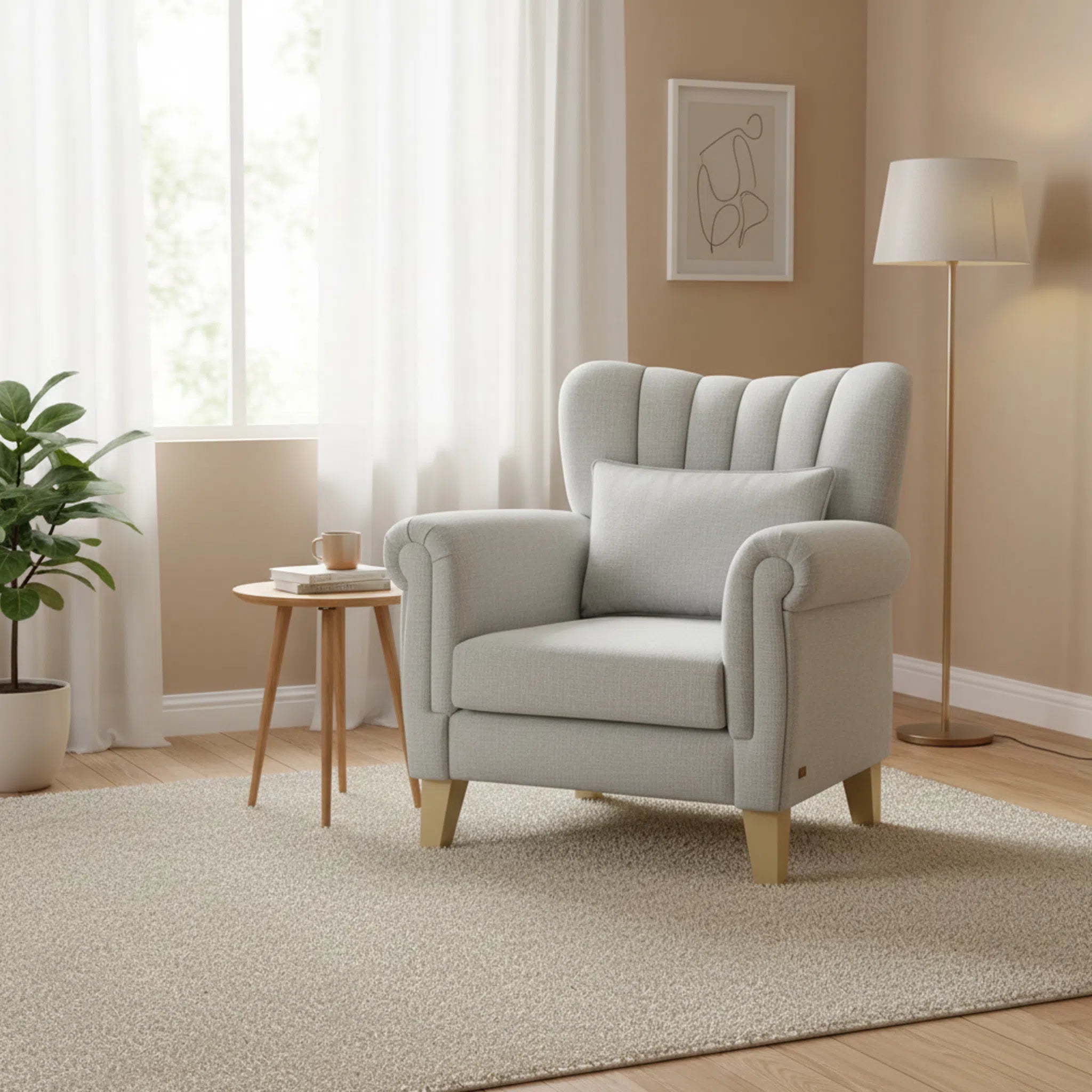 Gray armchair in a living room with a plant, side table, and lamp.