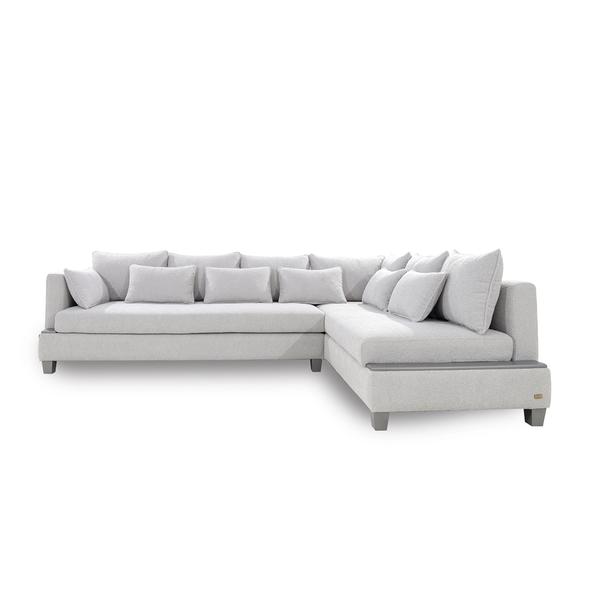 Gray sectional sofa with multiple cushions on a white background