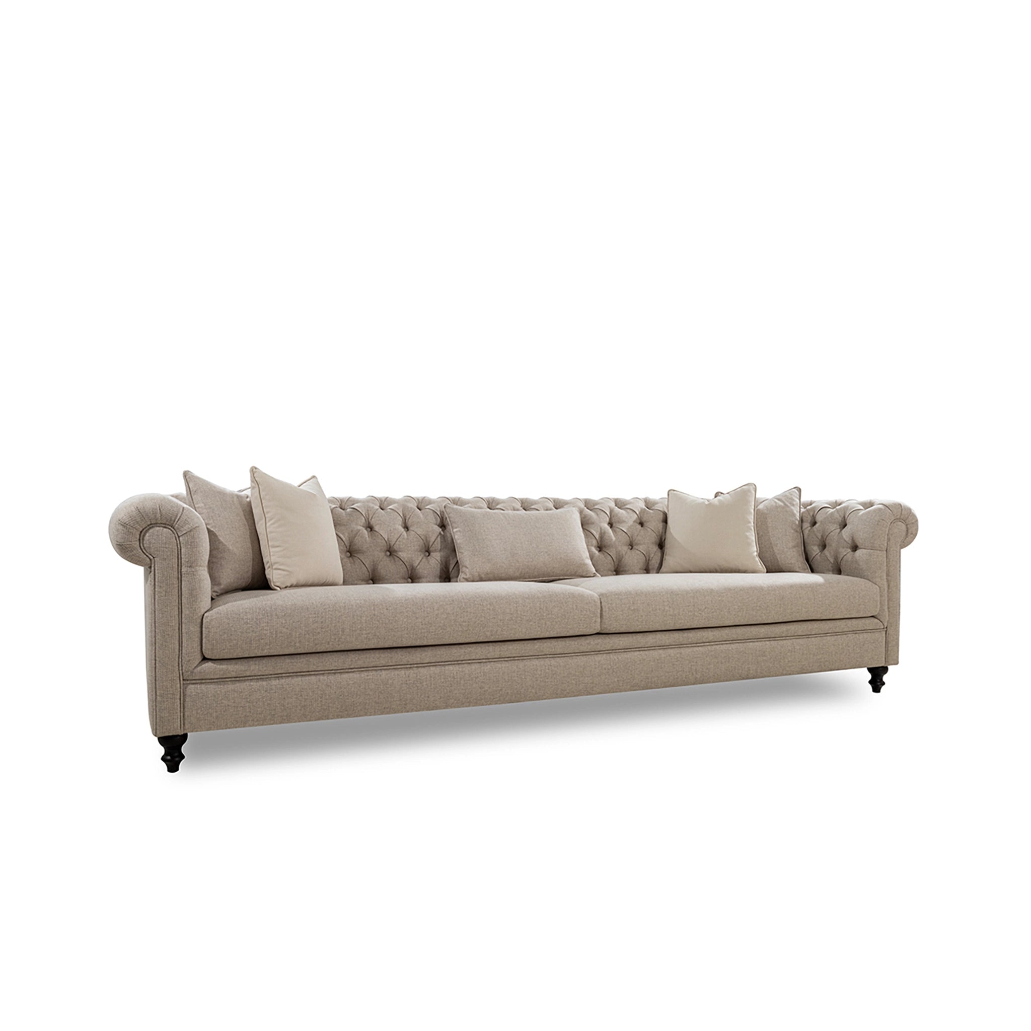 Beige tufted sofa with decorative pillows on a white background