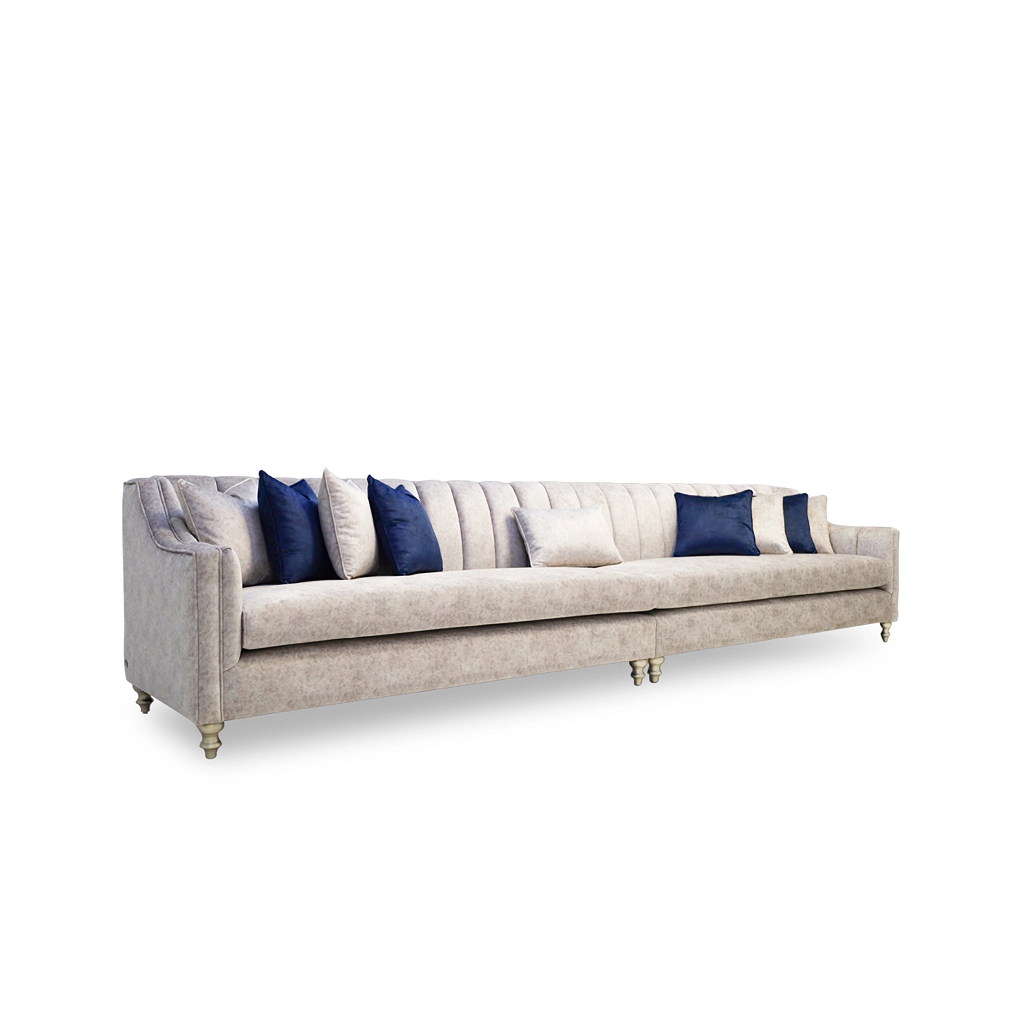 Long beige sofa with blue and white pillows on a white background