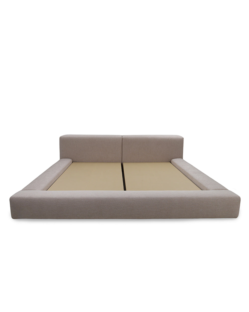 Beige upholstered bed with a white background