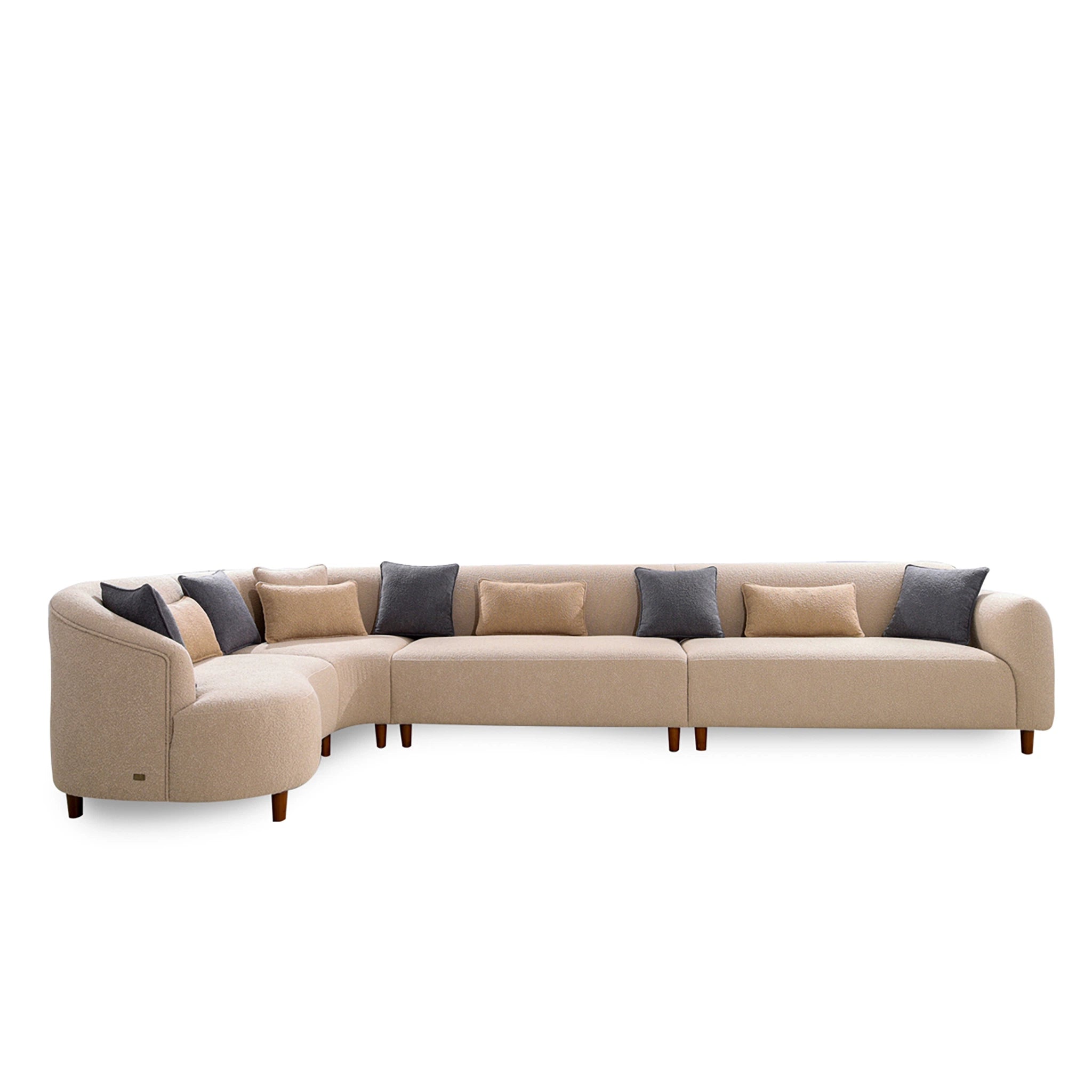 Beige sectional sofa with dark blue and gray cushions on a white background