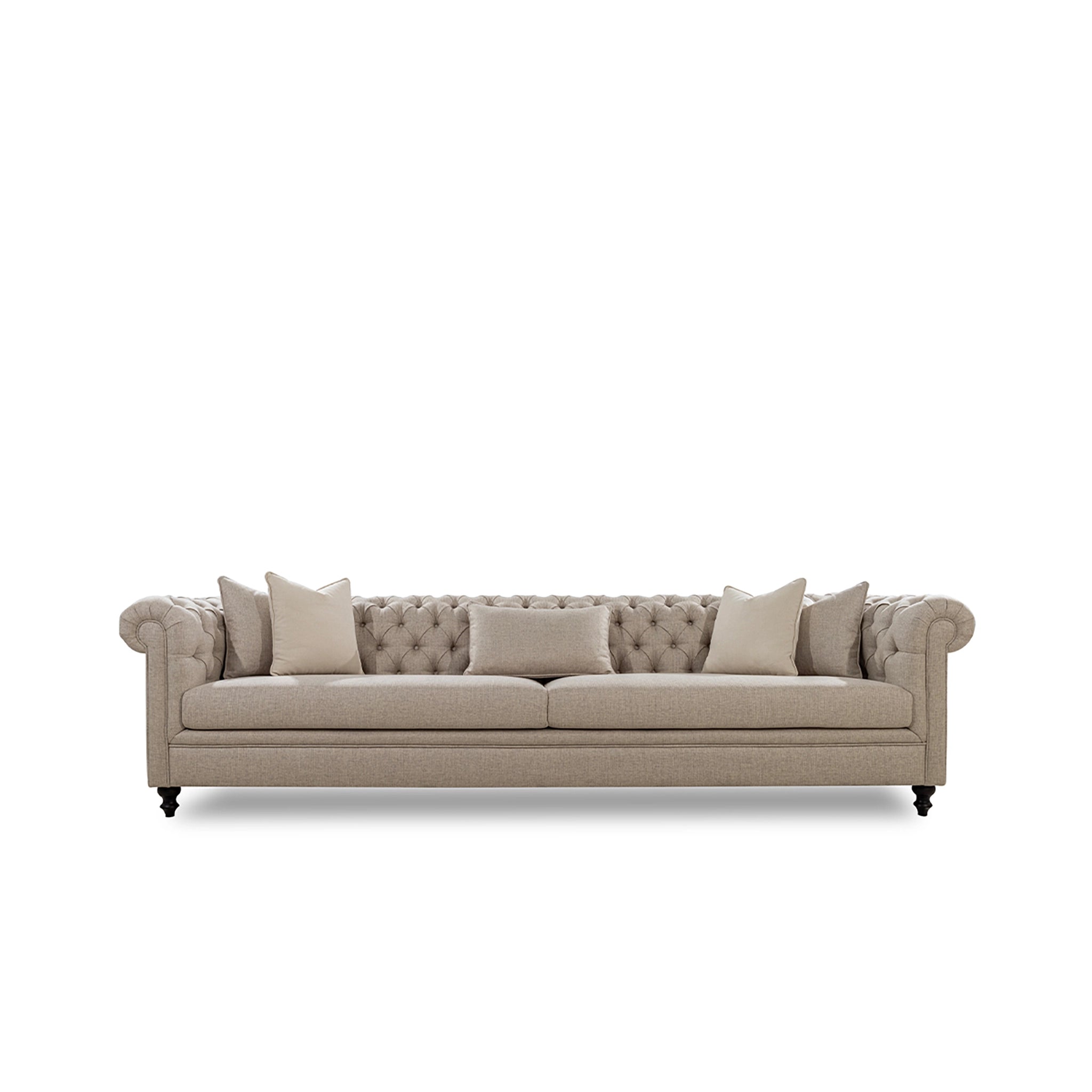Beige sofa with tufted backrest and four cushions on a white background