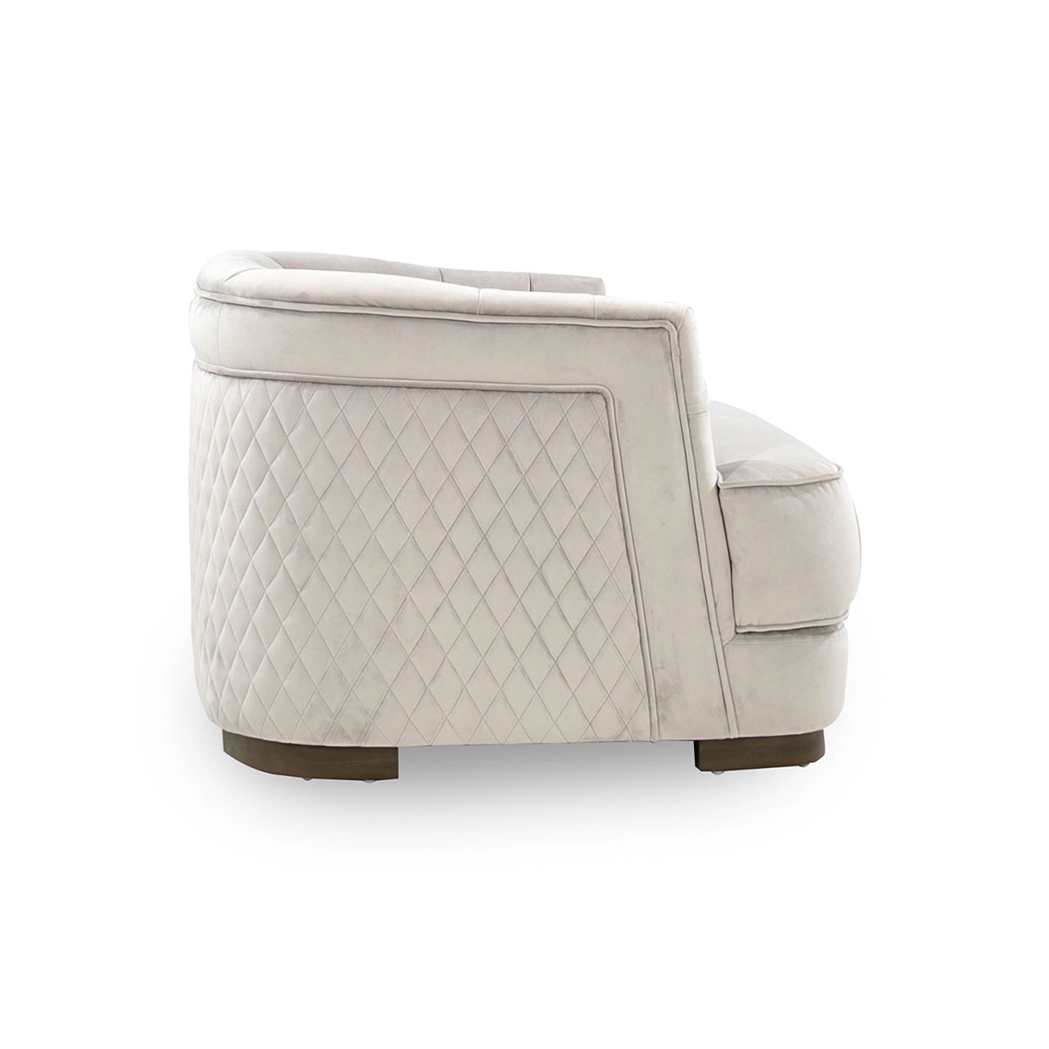 Beige quilted armchair on a white background