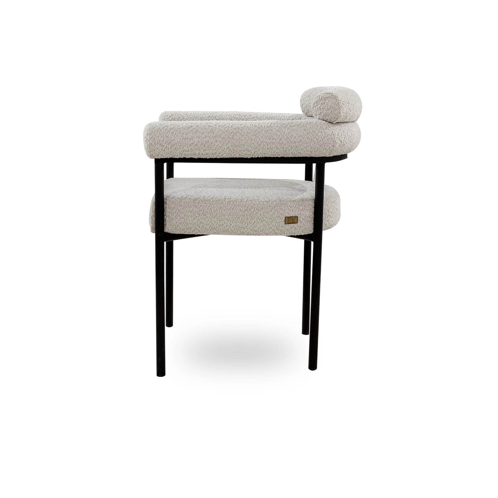 Beige cushioned stool with black legs on a white background