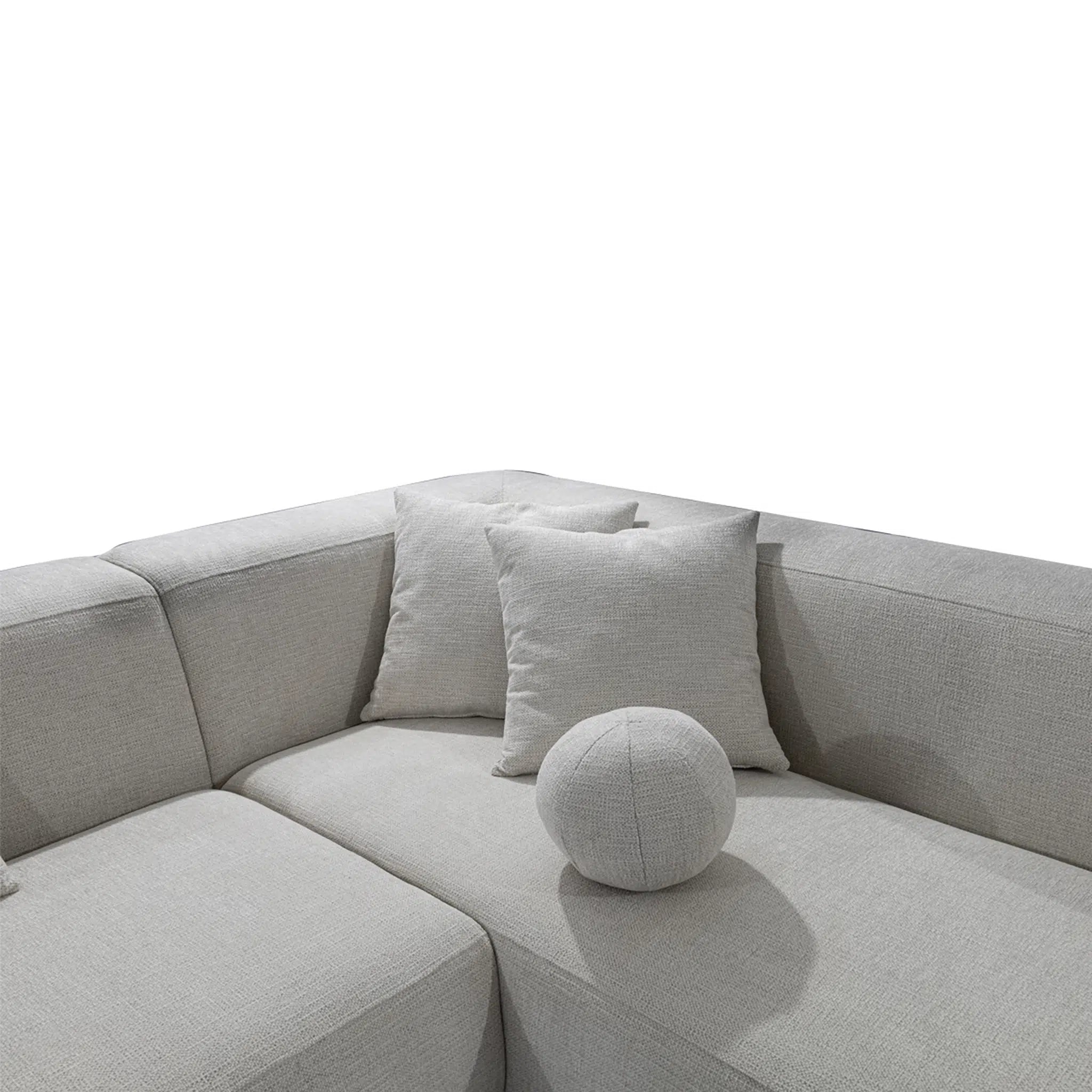 Gray sectional sofa with cushions on a white background