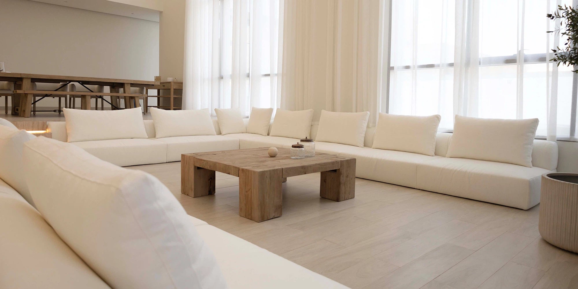 Modern living room with a beige sectional sofa and wooden coffee table.