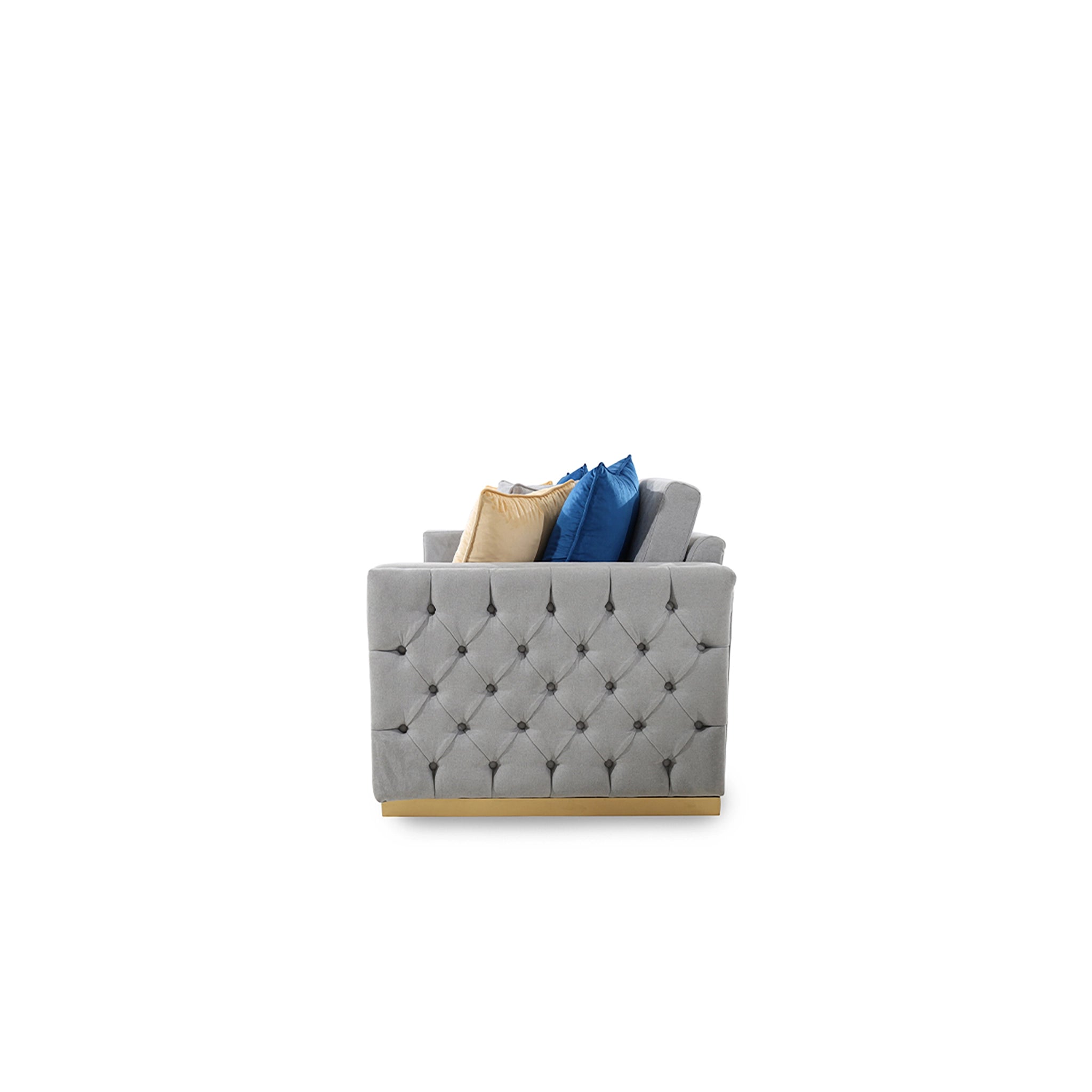 Gray tufted ottoman with decorative pillows on a white background