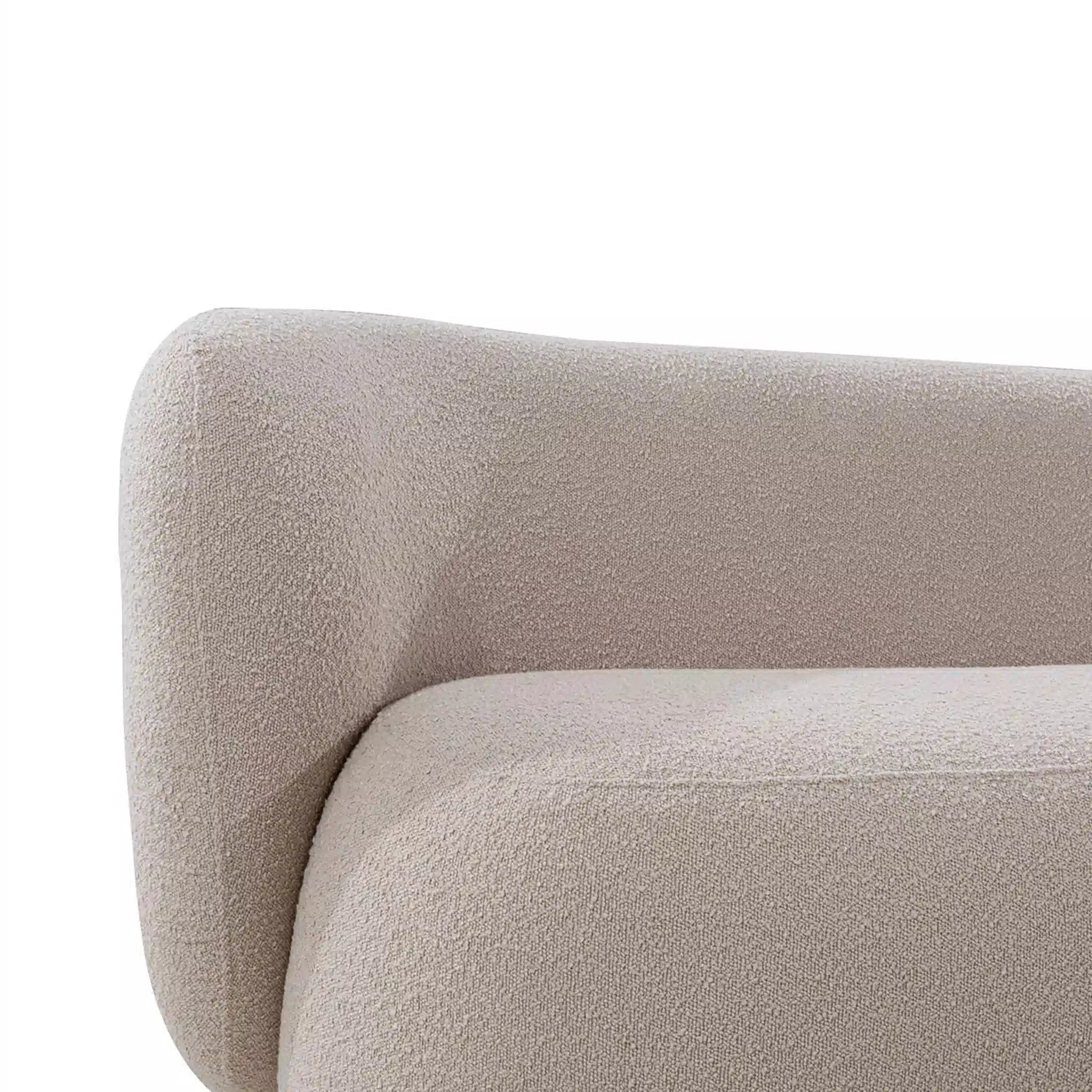 Close-up of a textured beige sofa corner on a white background