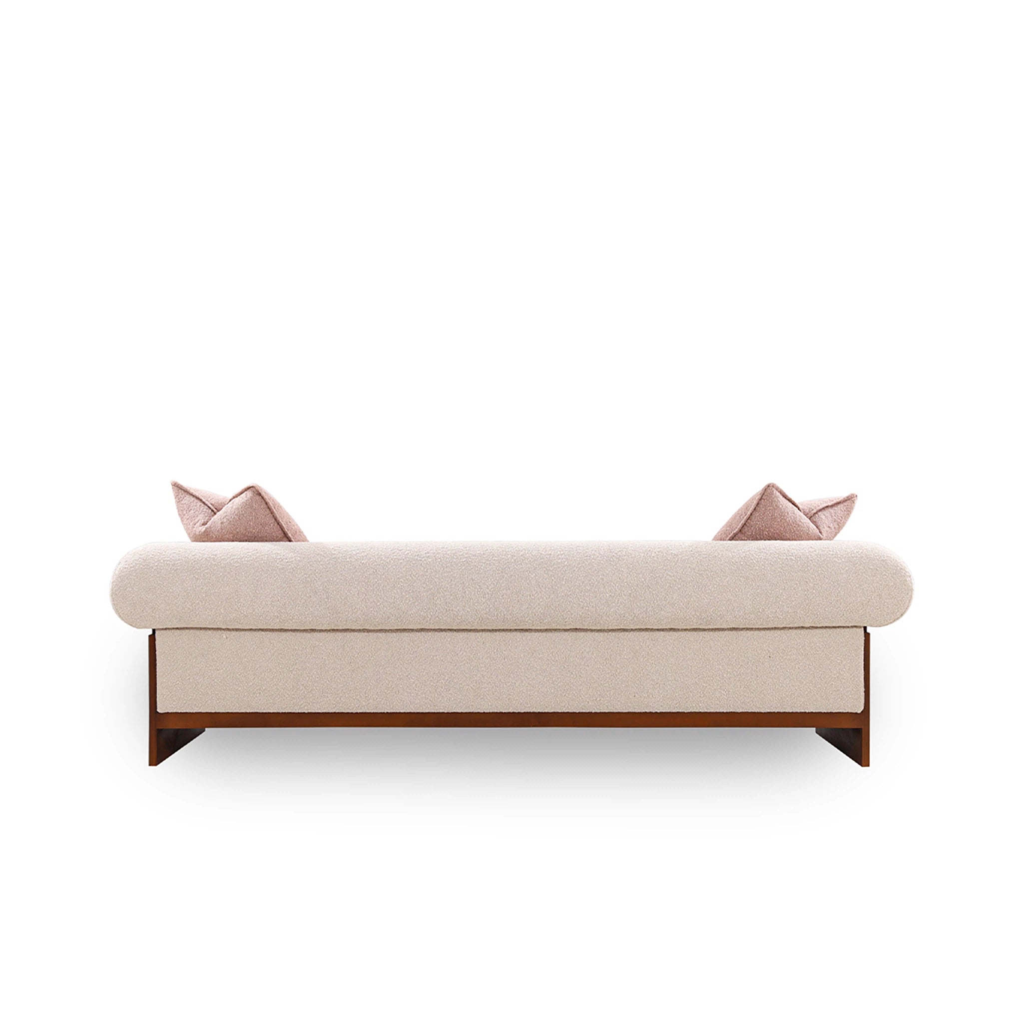 Beige sofa with wooden legs and pink cushions on a white background