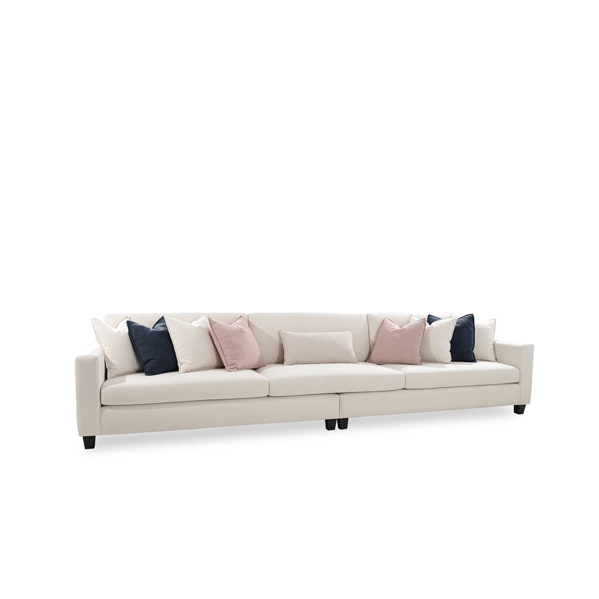 Beige sofa with decorative pillows on a white background