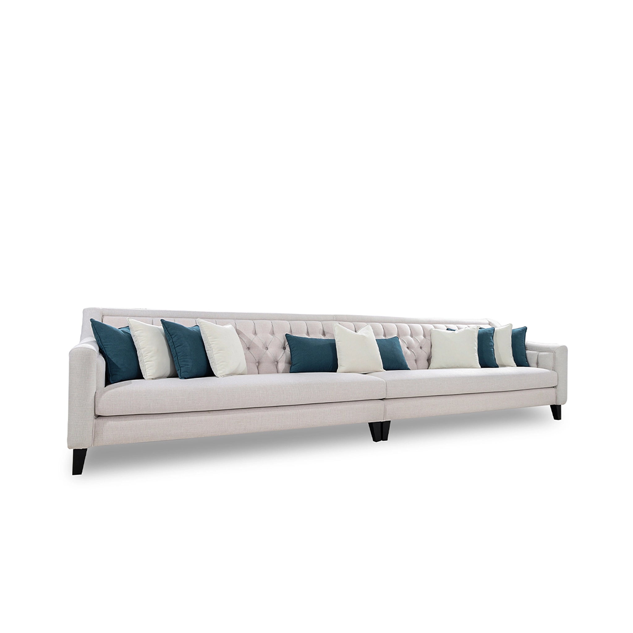 Beige sofa with blue and white pillows on a white background