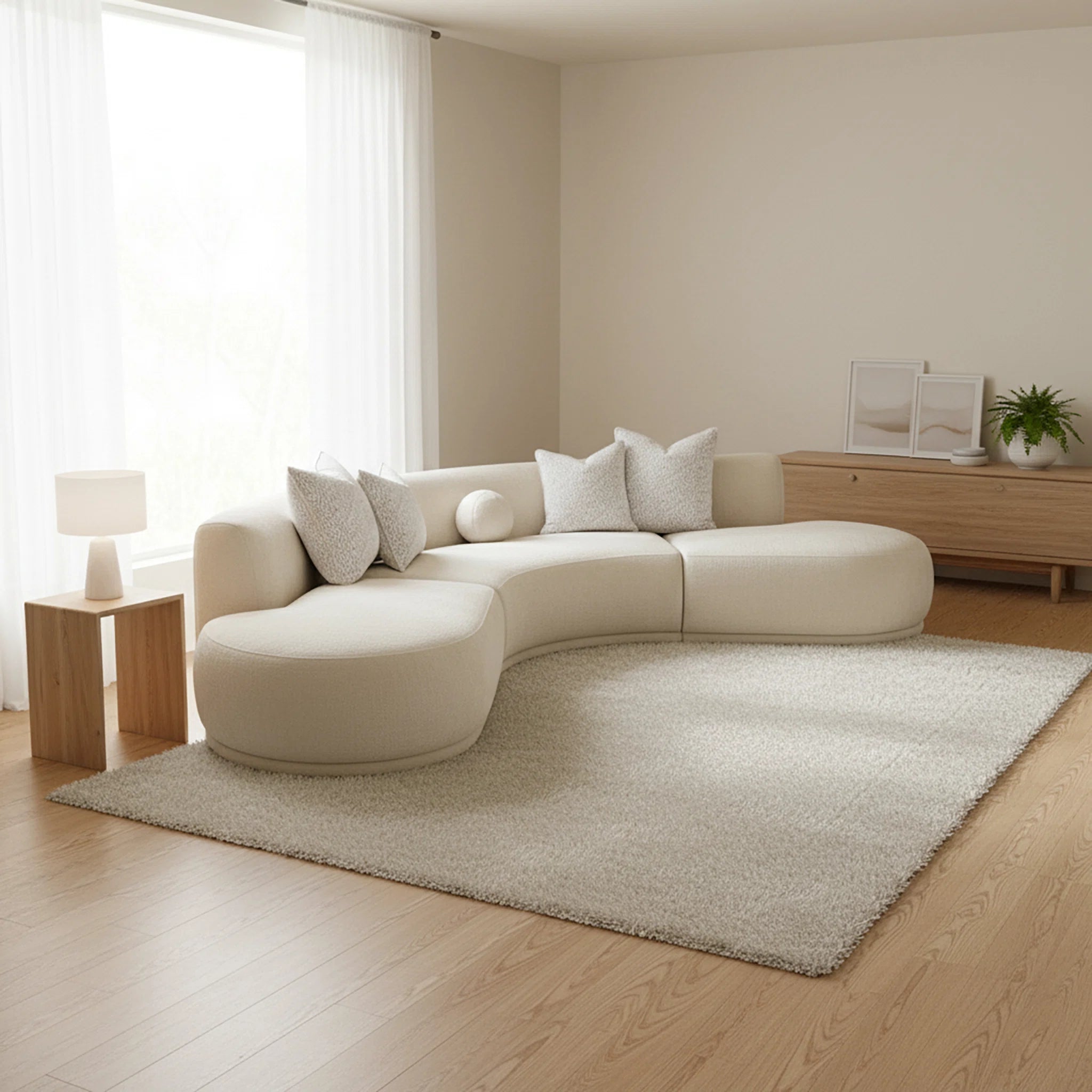 Modern living room with a beige sectional sofa, rug, and side table.