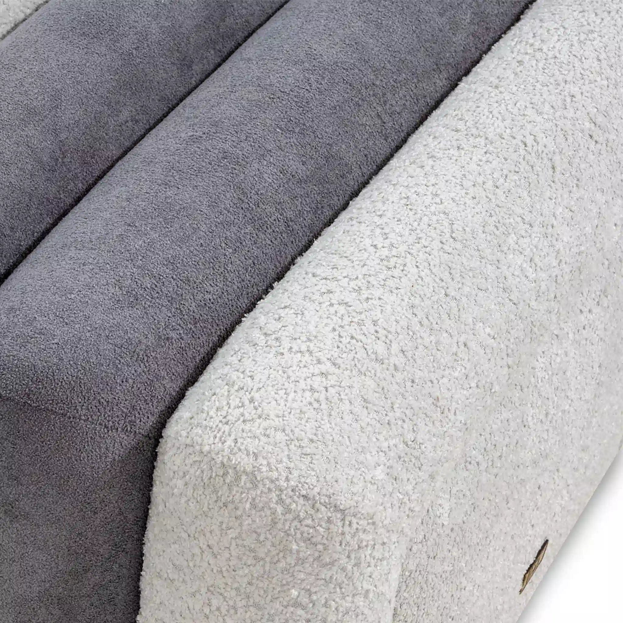 Close-up of textured fabric swatches in gray and white.