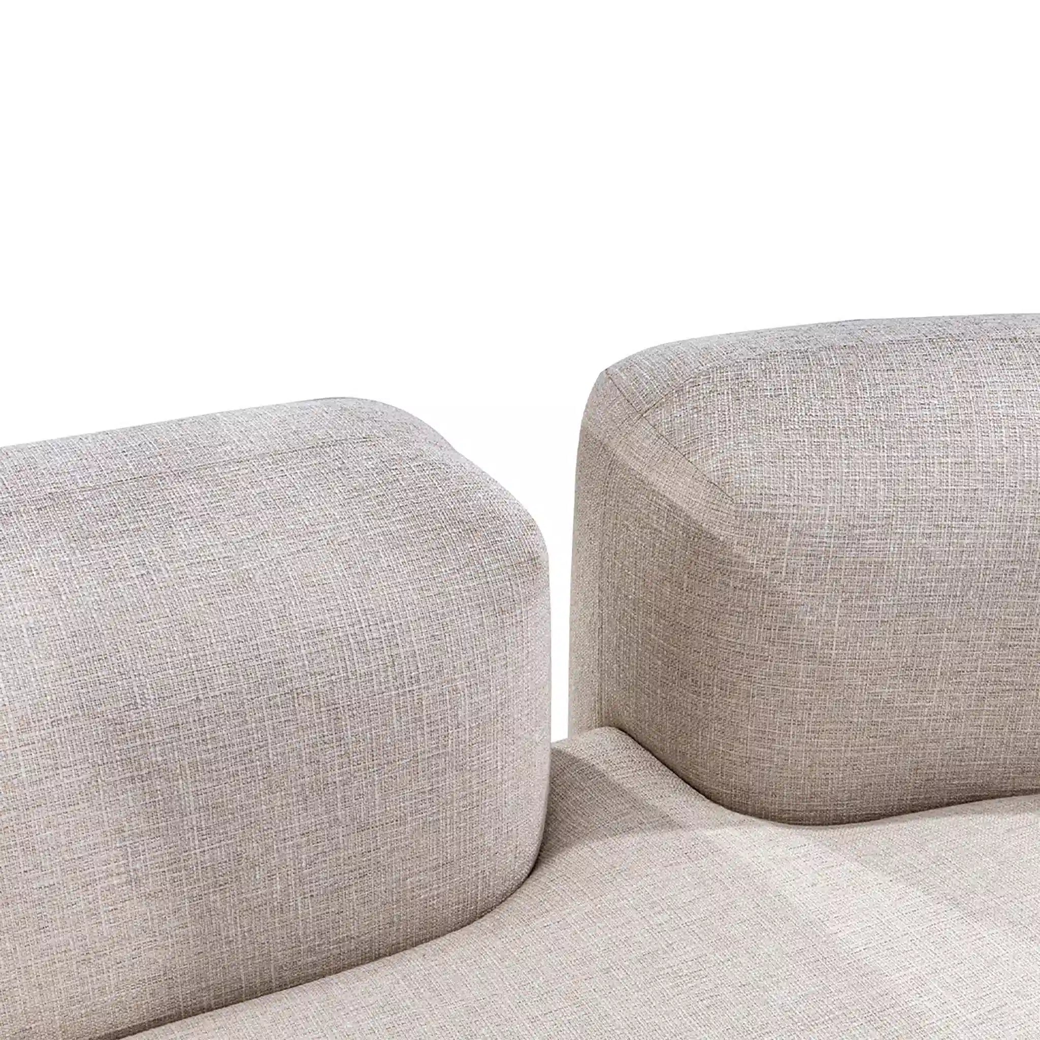 Close-up of a beige fabric sofa with a plain white background