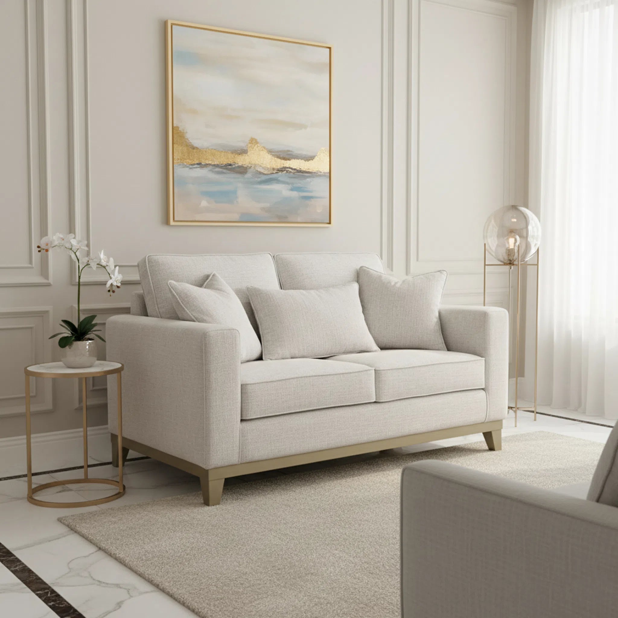 Beige sofa in a living room with abstract art and side table.