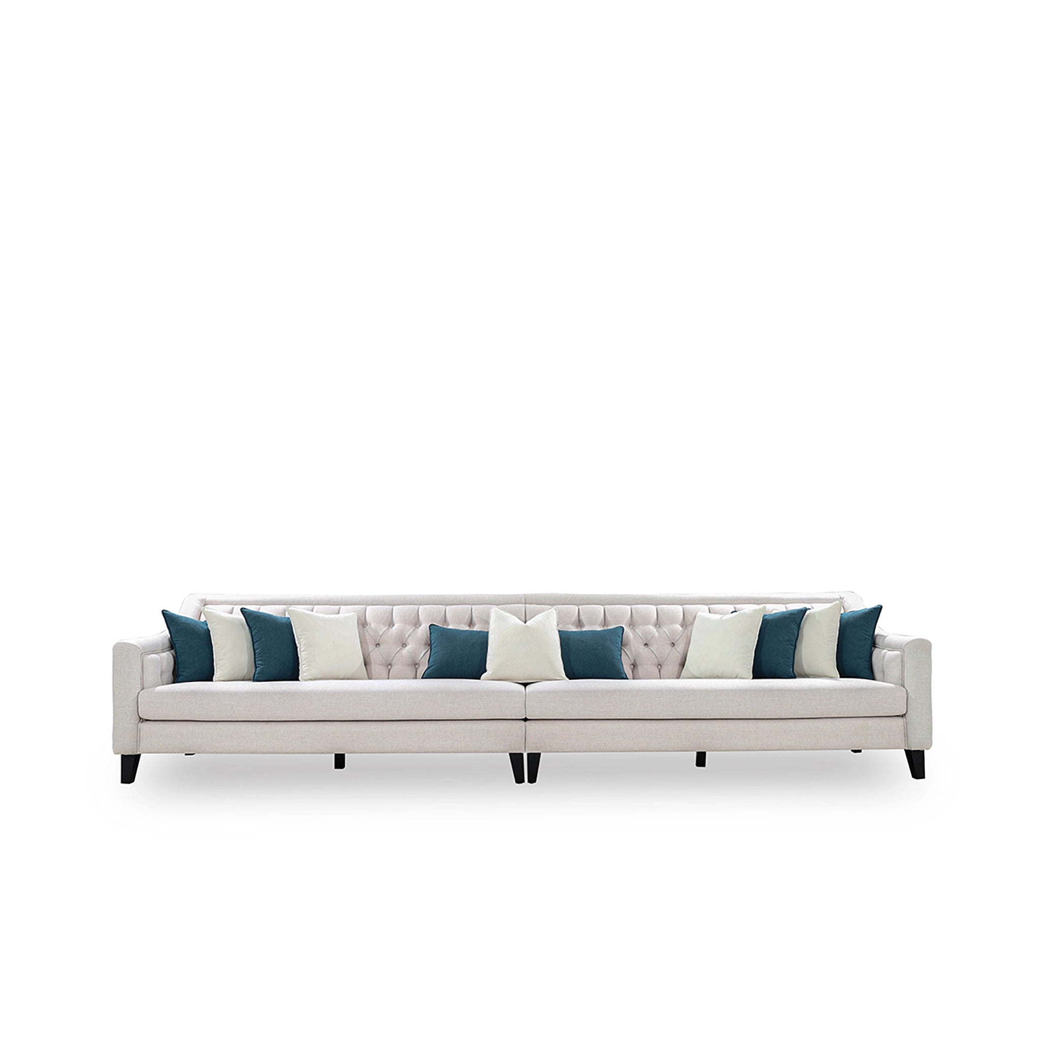 Beige sofa with blue and white pillows on a white background