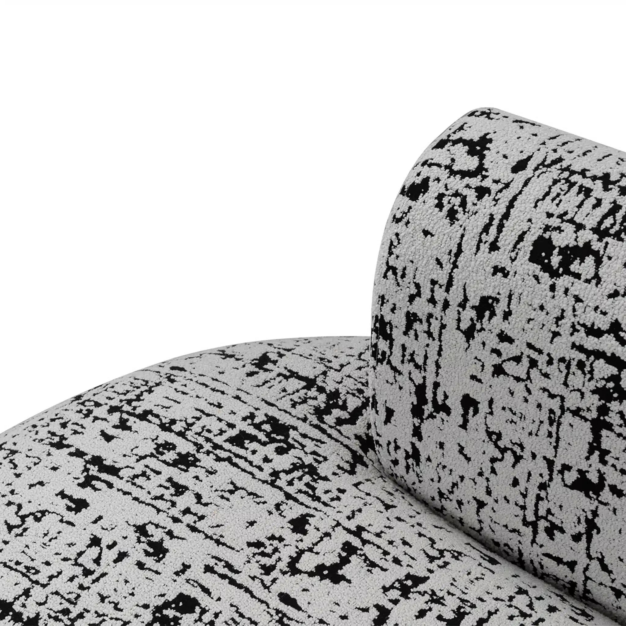 Close-up of a textured black and white sofa with a white background
