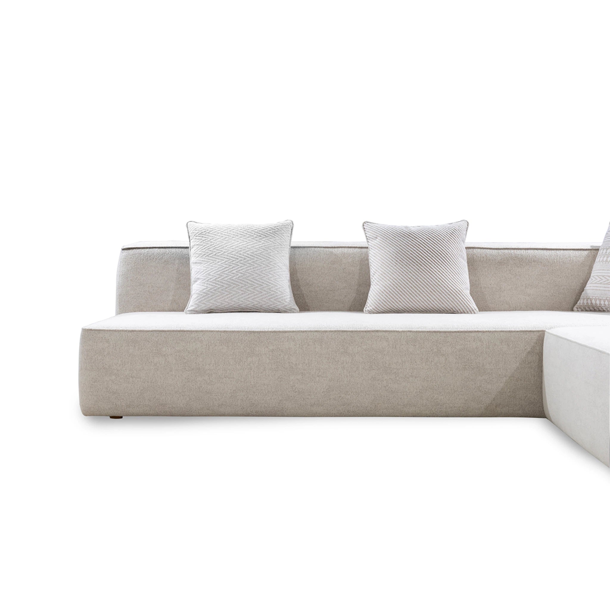 Beige sofa with two white pillows on a white background