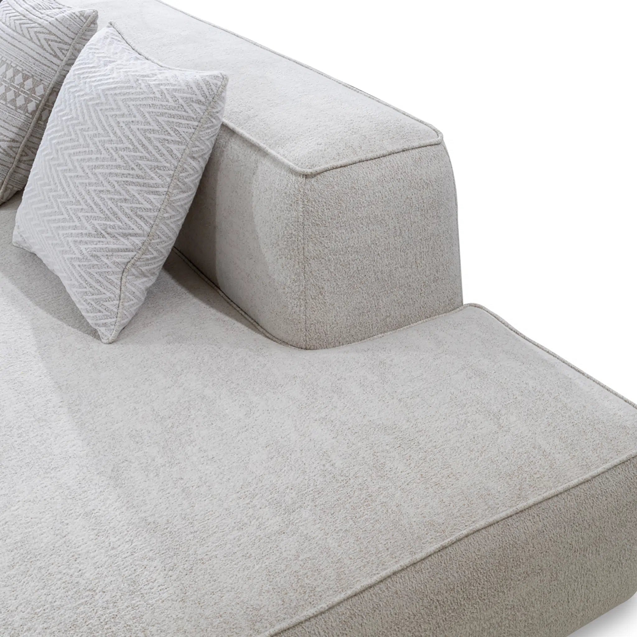 Gray fabric sofa with textured cushions on a white background