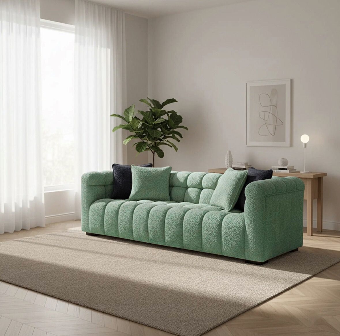 Green sofa in a living room with a plant and decor items.