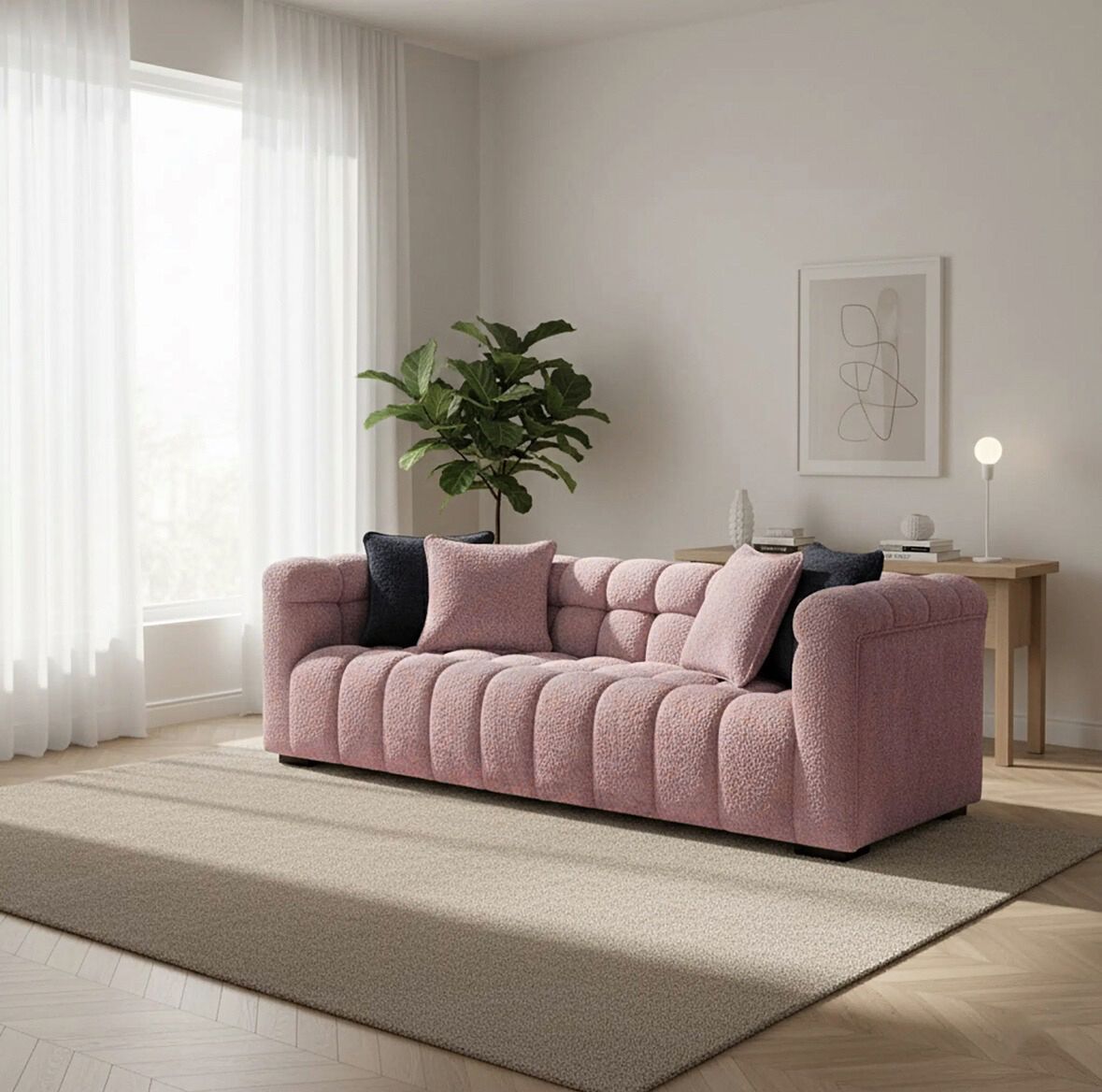 Pink sofa in a living room with a plant and side table.