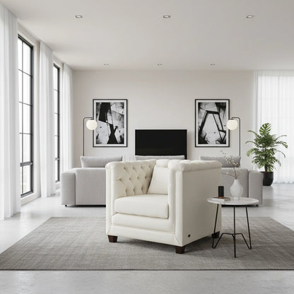 Modern living room with white armchair, sofa, and decorative elements.