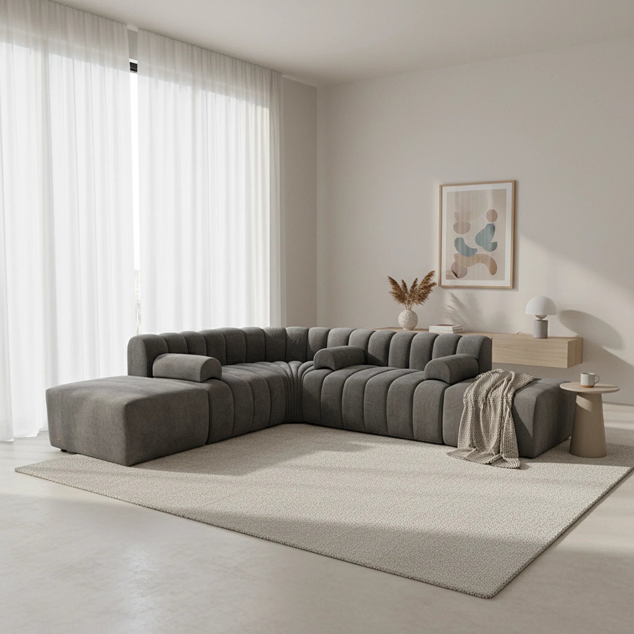 Modern living room with a gray sectional sofa, coffee table, and decorative elements.