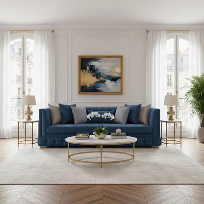 Modern living room with a blue sofa, coffee table, and abstract art on the wall.