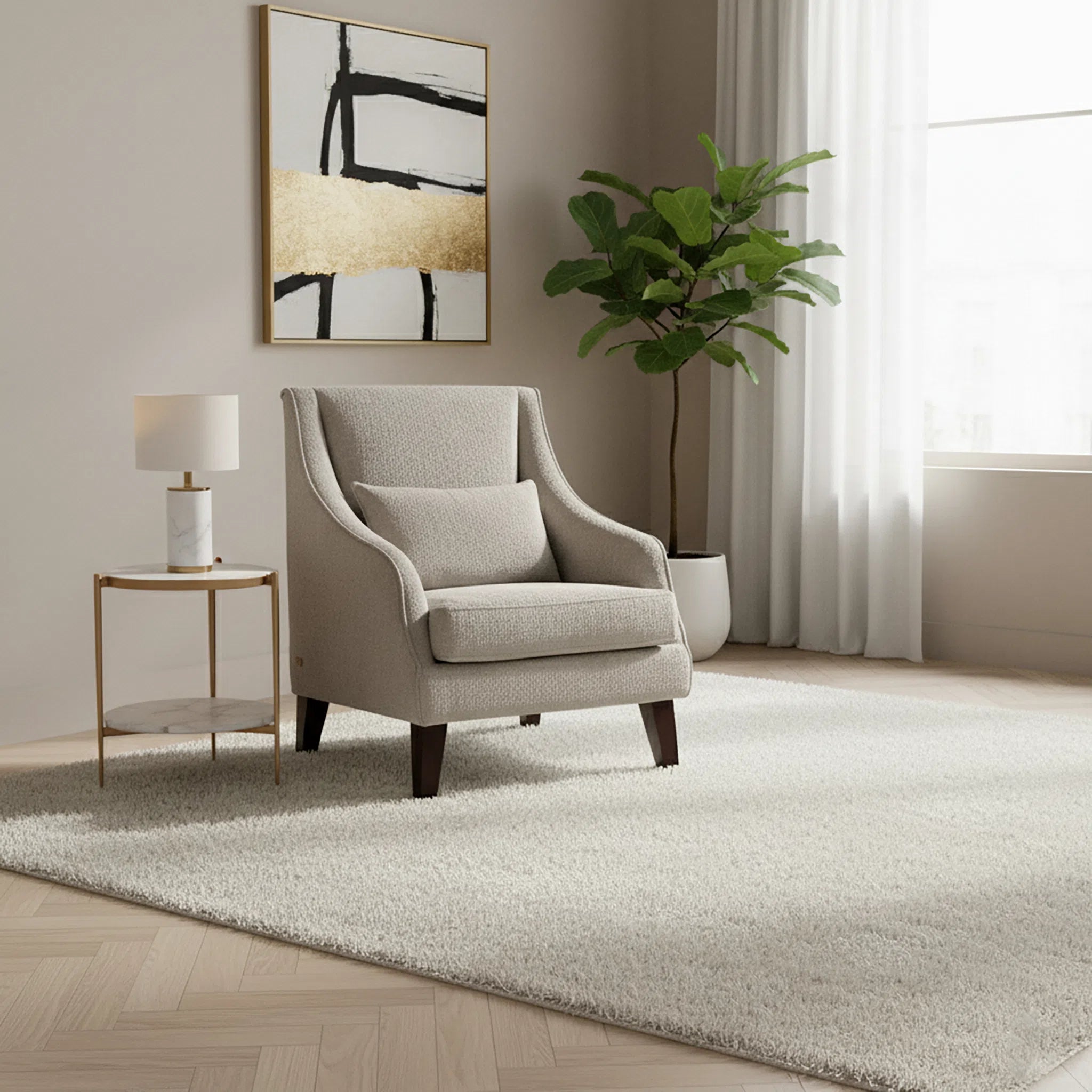 Beige armchair in a living room with a side table, lamp, and abstract painting.