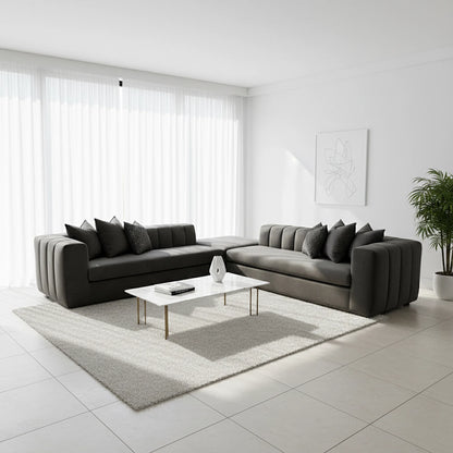 Modern living room with a gray sectional sofa, coffee table, and decorative items.