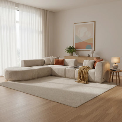 Modern living room with a beige sectional sofa, side table, and abstract art on the wall.