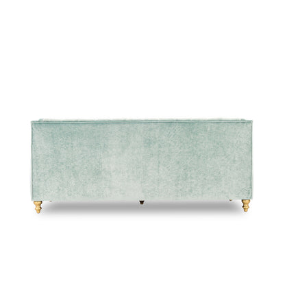 Light green upholstered bench with gold legs on a white background