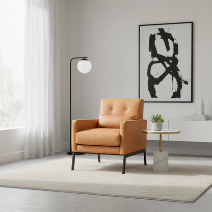 Modern living room with a tan armchair, abstract art, and floor lamp.