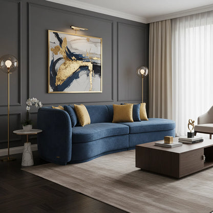 Modern living room with a blue sofa, abstract art, and decorative elements.