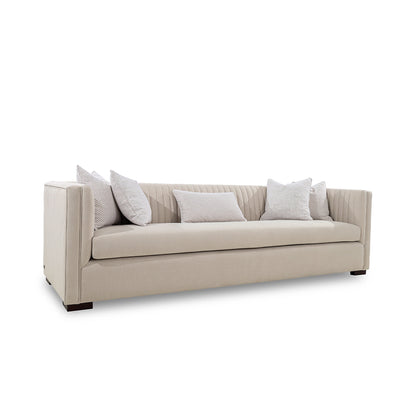 Beige sofa with decorative pillows on a white background