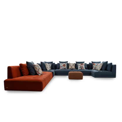 Sectional sofa with orange and blue cushions on a white background