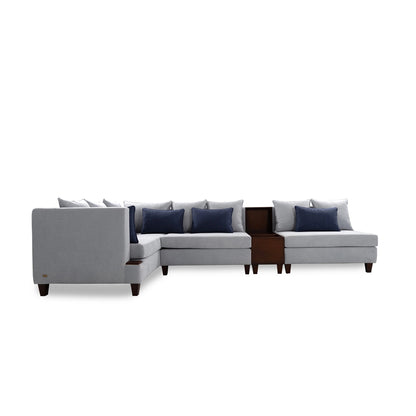 Gray sectional sofa with blue cushions on a white background