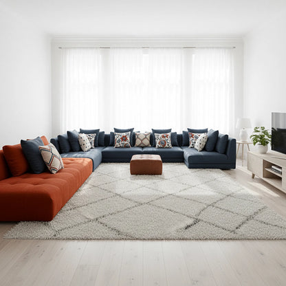 Modern living room with a sectional sofa, rug, and decorative pillows.