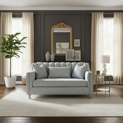 Living room with a gray sofa, decorative mirror, and framed pictures on a dark wall.