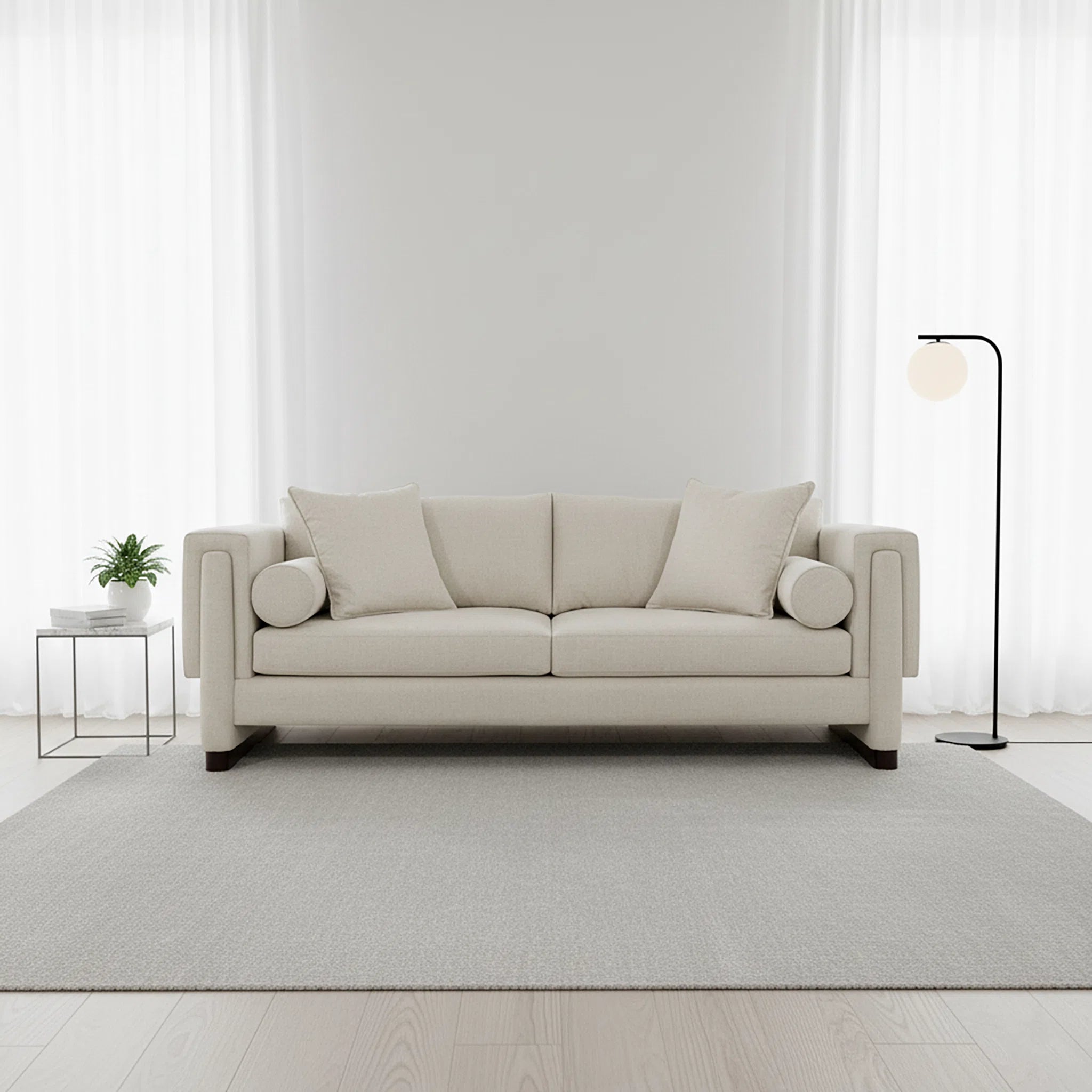 Beige sofa in a minimalistic living room with a white wall and light gray rug.