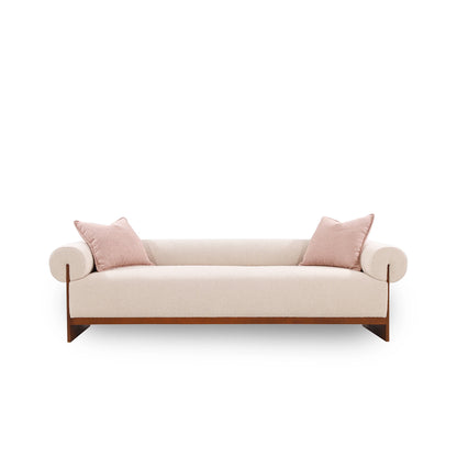 Beige sofa with pink cushions on a white background