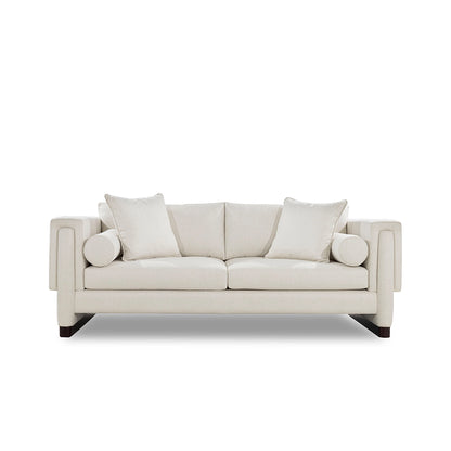 Beige sofa with two cushions on a white background