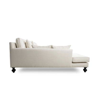 Beige sectional sofa with cushions on a white background