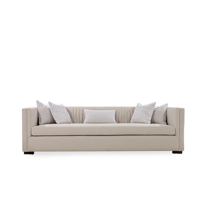 Beige sofa with decorative pillows on a white background