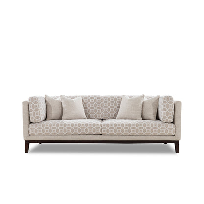 Beige patterned sofa with wooden legs on a white background