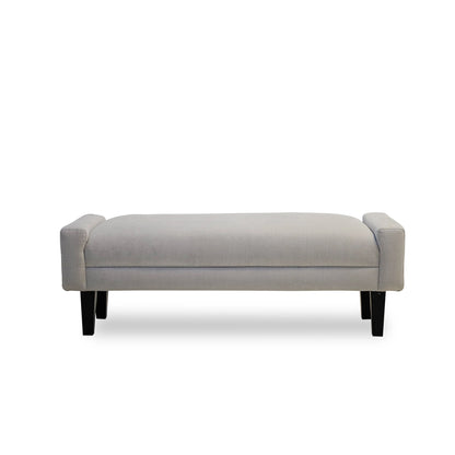 Gray upholstered bench with black legs on a white background
