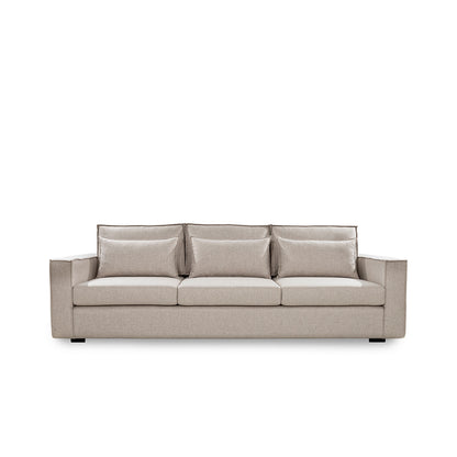 Beige sofa with three cushions on a white background