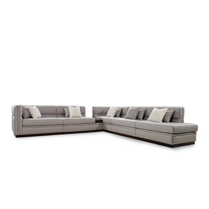 Gray sectional sofa with cushions on a white background