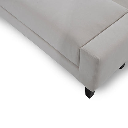 Gray upholstered bed corner on a white background